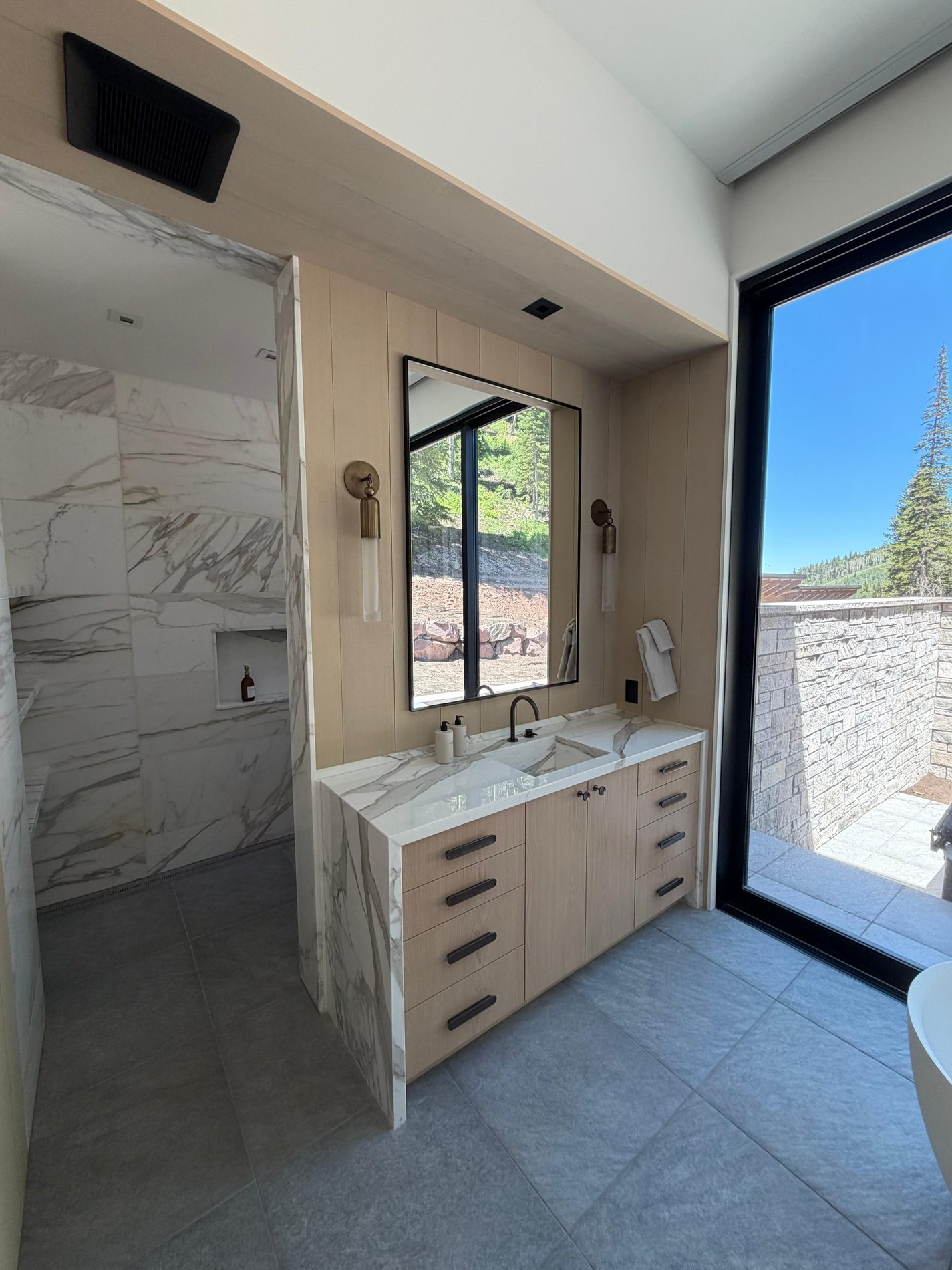 Finished primary bath detail with custom vanity millwork, mirror, and clean architectural trim